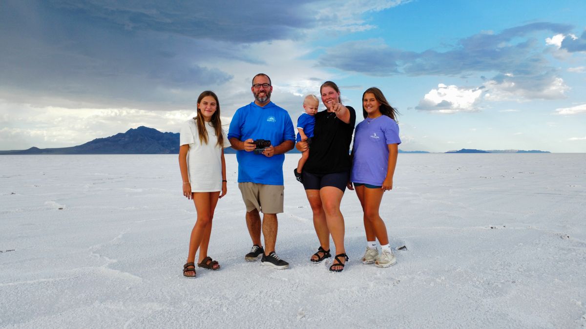 Wes Godwin with his wife and three kids standing on a white salt flat under a big sky